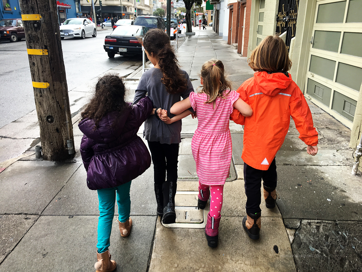 Little girls walking arm in arm